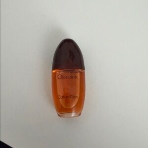 Calvin Klein Obsession Fragrance with Rich Brown and Orange Hues